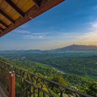 a view from a balcony of a valley with mountains at Ceyloni Panorama Resort, Kandy