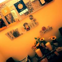 a room with a wall with flowers and magnets at A1 Girasole B&B, Castelnuovo di Porto