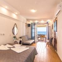 a hotel room with a bed and a view of the ocean at Nisyros White Wave, Mandrakion