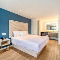 a bedroom with a large bed and a blue wall at Trend Hotel at LAX Airport, Inglewood