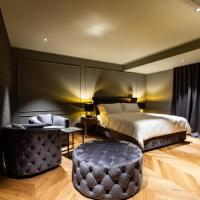 a hotel room with a bed and a stool at DAM boutique hotel & restaurant, Nova Gorica