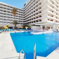 a swimming pool with chairs and a large building at BLUESEA Gran Cervantes, Torremolinos