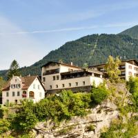 a village on a cliff with mountains in the background at Schlosshotel Dörflinger, Bludenz