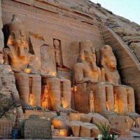a large stone wall with statues on it at Hllol Hotel, Abu Simbel
