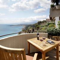 a table and chairs on a balcony with a view of the ocean at Eurostars Monte Tauro, Taormina