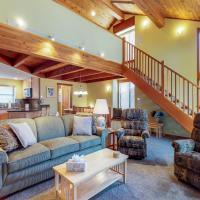 a living room with a couch and chairs and a staircase at Snowflower 21, Mammoth Lakes