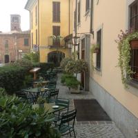 a courtyard with tables and chairs in a building at Antica Trattoria dell'Uva, Monza