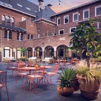 a patio with tables and chairs in front of a building at The Anthony Hotel, Utrecht