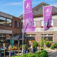 a restaurant with purple banners in front of a building at dS Hotel Bad Bentheim