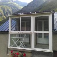 a conservatory on the side of a house with mountains at BOYRIE Daniel et Hélène, Gavarnie