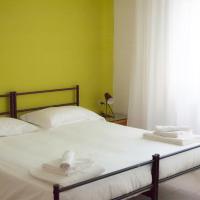 a bedroom with a bed with two towels on it at UniHo Hostel, Pavia
