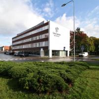 a large building in front of a parking lot at Forenom Serviced Apartments Rauma Kaivopuisto