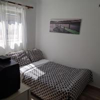 a bedroom with two twin beds and a television at Sky line center city Dimitropoulos, Aigio