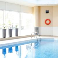 a swimming pool in a room with a large window at Novotel Sheffield Centre