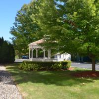 a white house with a gazebo in the yard at Holiday Inn Express Hotel & Suites West Point-Fort Montgomery, an IHG Hotel