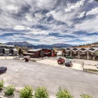 an empty parking lot in a small town with mountains at Beautiful Mountain View Condo, Crested Butte