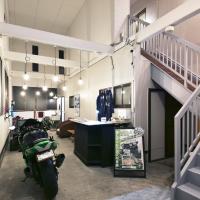 a room with a motorcycle parked in it at Guesthouse 66, Kakuda