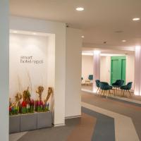 an office lobby with chairs and a green door at Smart Hotel Napoli, Naples
