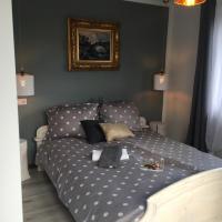a bed with polka dot sheets in a bedroom at Apartamenty i pokoje u Staszelów, Poronin