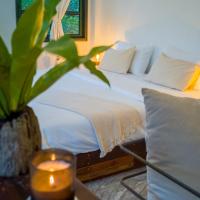 a bedroom with a bed with a candle on a table at Big Tree Boutique Hotel, Ko Tao