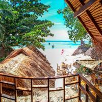 a beach with chairs and umbrellas and the ocean at Forra Pattaya Beach Front Bungalow, Ko Lipe