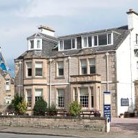 a large house with a tower on top of it at Club House Hotel & Restaurant, Nairn