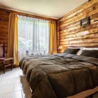 a bedroom with a wooden wall with a bed in it at B&B Casapuelo, Lago Puelo