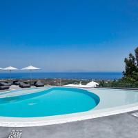 a swimming pool with chairs and umbrellas and the ocean at Aperanto Suites, Oia