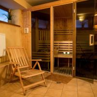 a rocking chair on a balcony with a table at Hotel Solny, Wieliczka