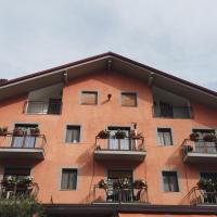 a large orange building with balconies and potted plants at Hotel Cristina, Verrayes