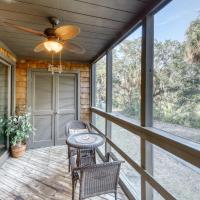 a porch with a ceiling fan and a table and chairs at 4270 Mariner's Watch Villa, Kiawah Island