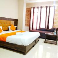 a bedroom with a large bed and a chair at Hotel Sukhman Residency, Amritsar