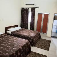a hotel room with two beds and a mirror at Hotel du Golfe de Guinee, Conakry