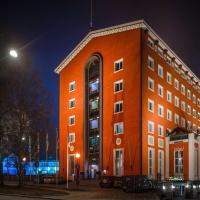 a large orange building at night at Radisson Blu Grand Hotel Tammer, Tampere
