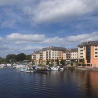 a group of boats docked in a river with buildings at Radisson Blu Hotel, Athlone