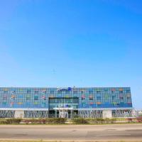 a large blue building with a lot of windows at Radisson Blu Hotel, Abidjan Airport