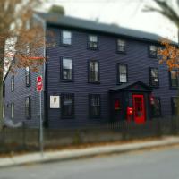 a large blue house with a red door on a street at The Daniels House Bed and Breakfast, Salem