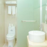 a white bathroom with a toilet and a sink at Shell Jiaxing Jiashan Shenyou Road Hotel
