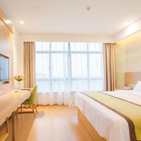 a hotel room with a bed and a desk and a television at GreenTree Inn Wuxi Huishan District Yangshan Town Jiayang Life Plaza Business Hotel, Jiaxing