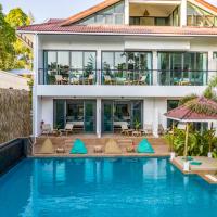a villa with a swimming pool in front of a house at By The Sea Koh Mak Boutique Guesthouse, Ko Mak