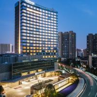 a large building with a road in front of it at Pullman Shanghai Qingpu Excellence