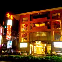 a building on a city street at night at Jin Spa Resort Hotel, Jinshan