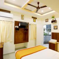 a bedroom with a bed and a ceiling fan at Base9 Cochin Airport Hotel, Nedumbassery