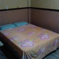 a small bed in a room with a unintention at Ligaya's Pension House, Tubigon