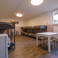 a room with bunk beds and a table and chairs at sbchostel, Kreuzlingen