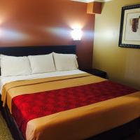 a hotel room with a bed with a red blanket at Baymont by Wyndham Ontario