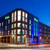 a large building with blue lights on the side of it at Holiday Inn Express - Barrow-in-Furness & South Lakes, an IHG Hotel, Barrow in Furness