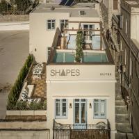 an aerial view of a white building with a sign that reads shapes at Shapes Luxury Suites, Ermoupoli