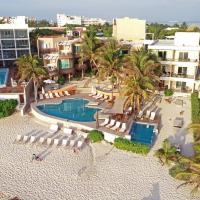 an aerial view of a resort with a pool and chairs and palm trees at Hotel Playa La Media Luna, Isla Mujeres