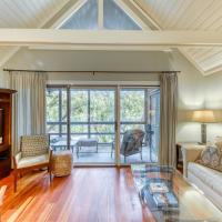 a living room with a couch and a tv at 4285 Mariner's Watch Villa, Kiawah Island